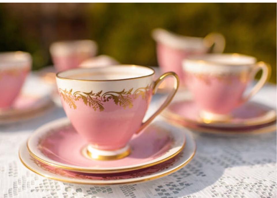Pink teacups on a table outdoors