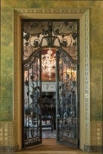 Ironwrought interior door leading to a sunroom